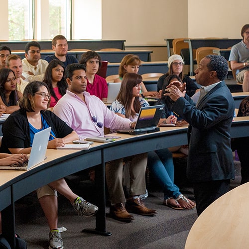 Professor teaching to a class of students.