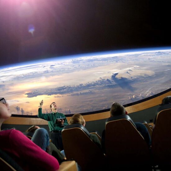 Students are watching a 3D film with the professor explaining the images.