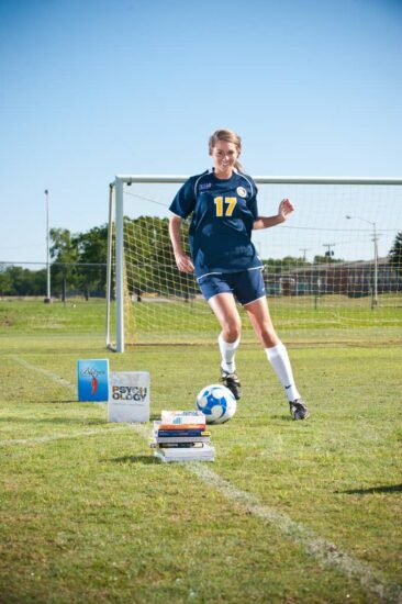 Brittni Ong playing football in ground