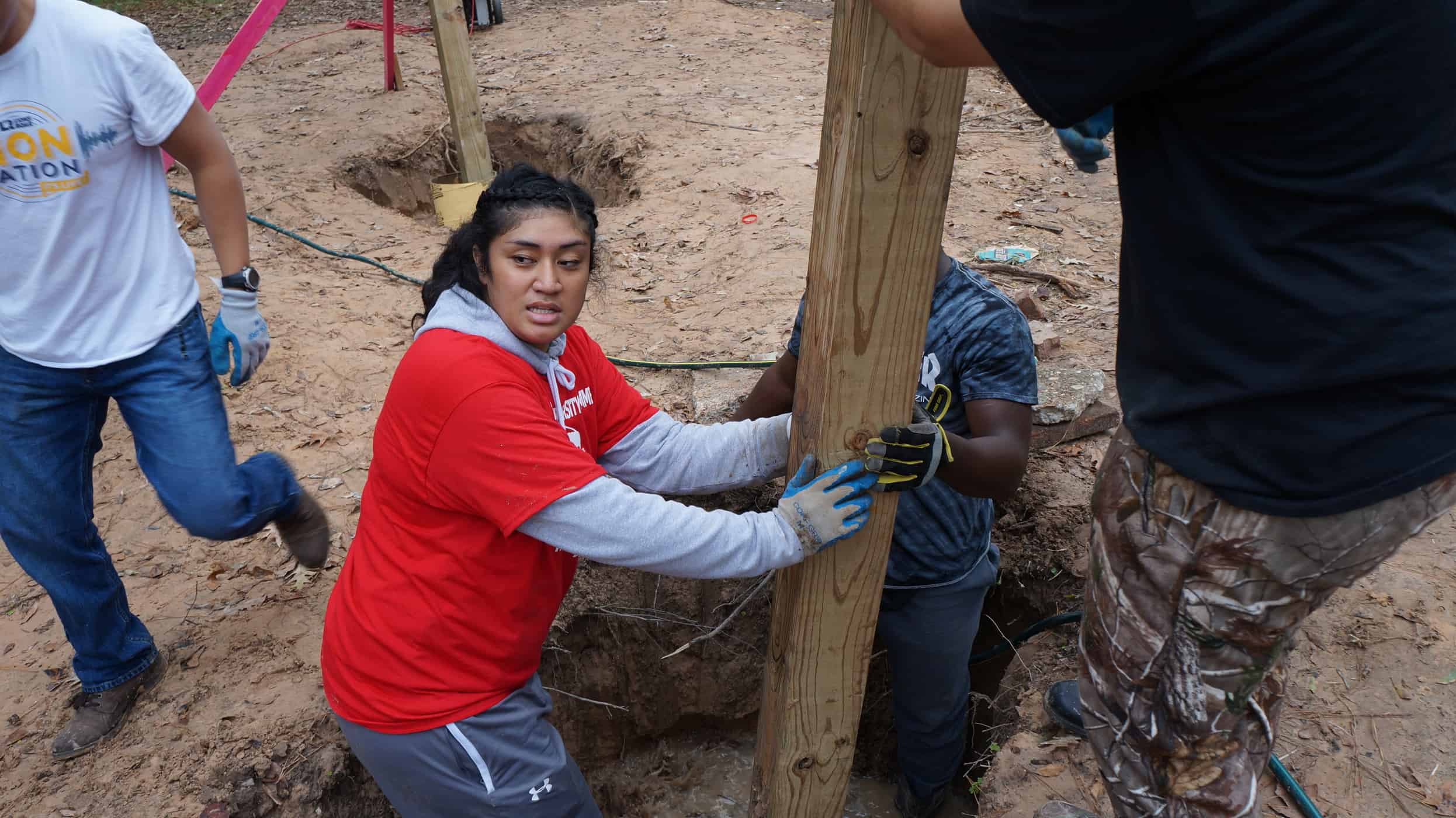 An individual holding a 4x4 pole