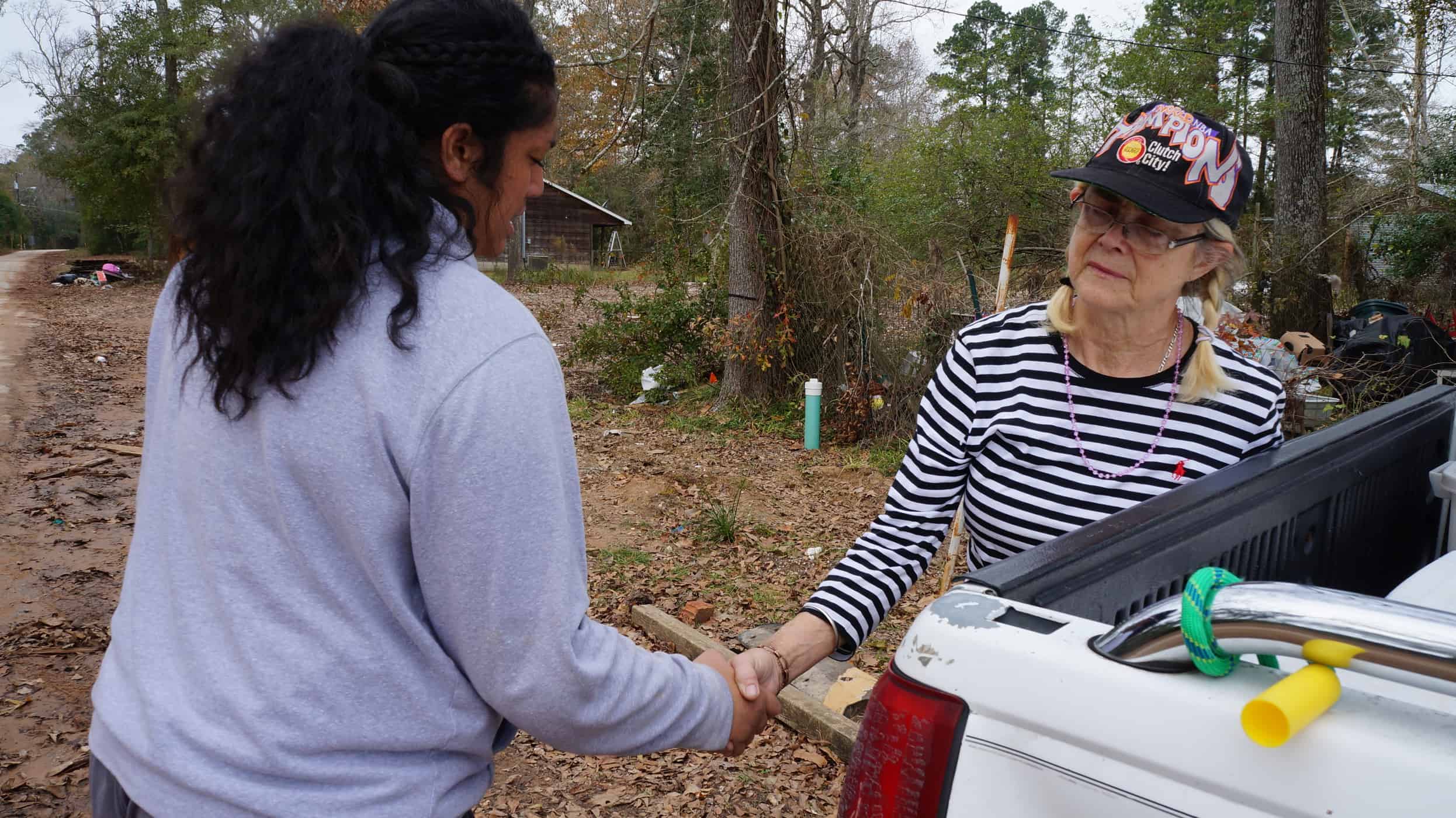 A lady giving something to a student.