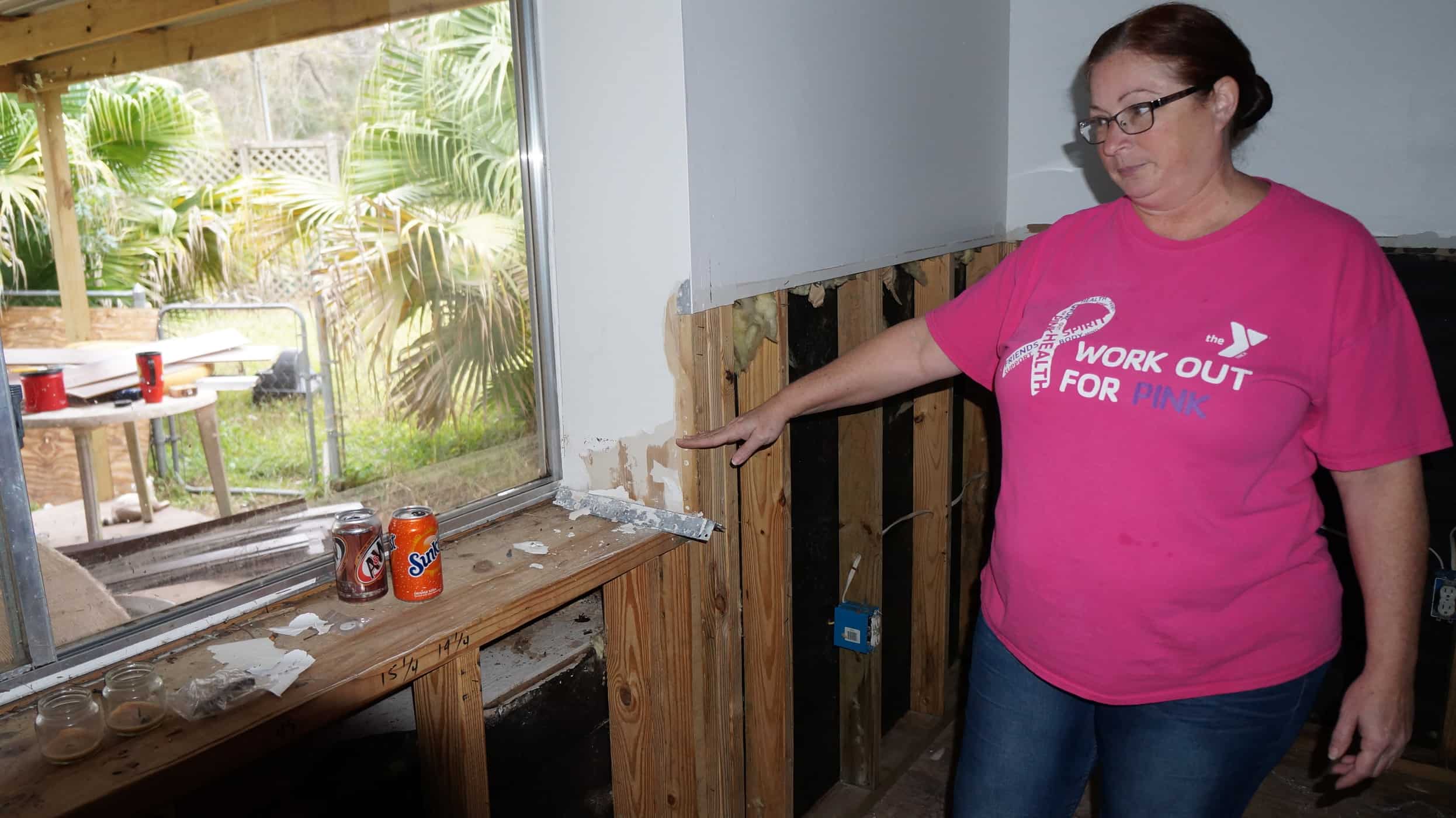 An individual pointing to something on a shelf