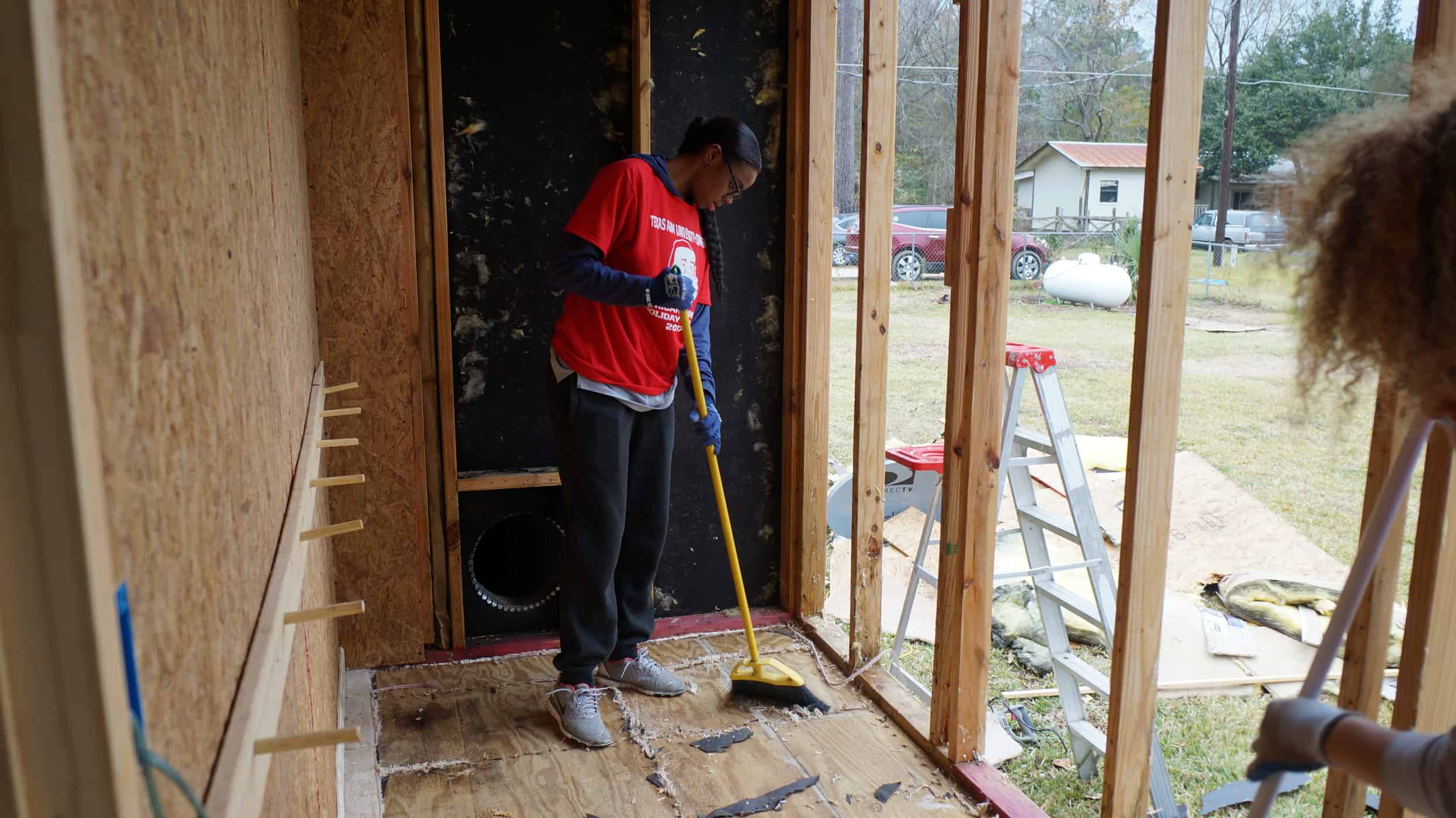 Individual in a room brooming