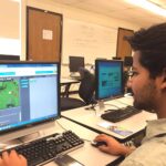 an individual on he computer looking at software.