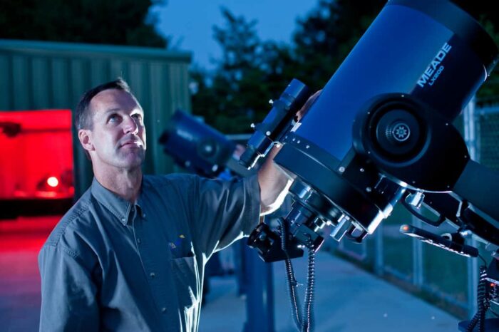 Person holding telescope