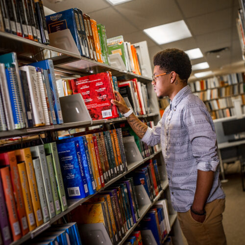 student in library