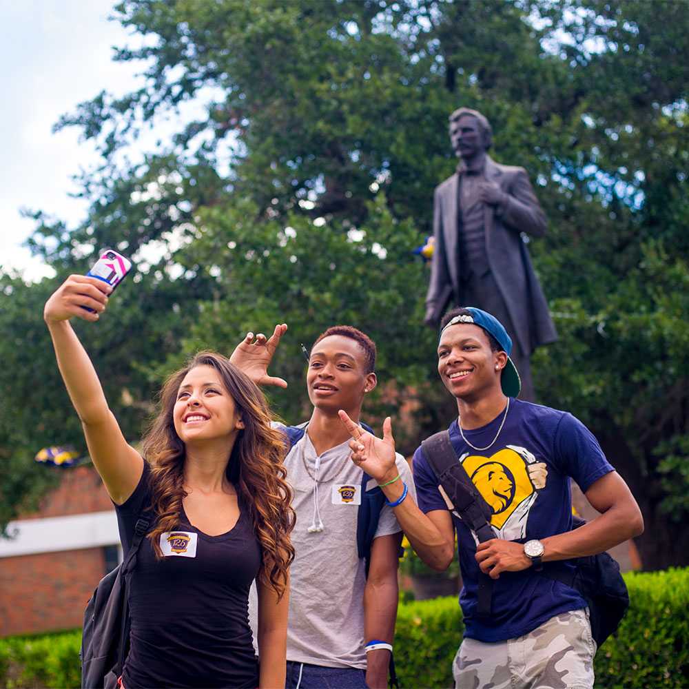 Three students taking a selfie wearing East Texas A&M shirts.