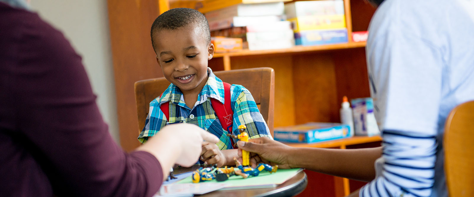 Young kid playing at a table.