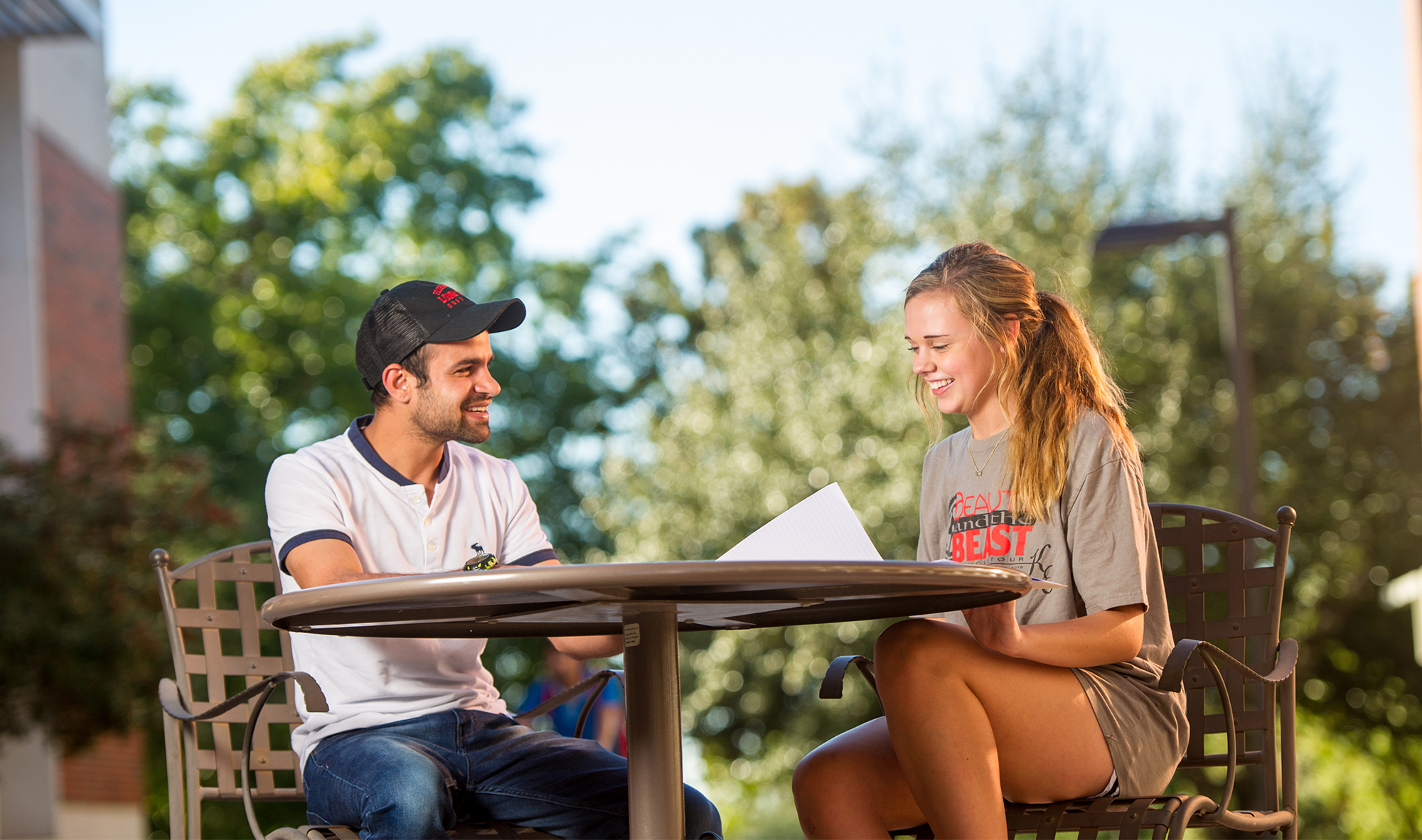 A female and male sitting at a table studying for a class.