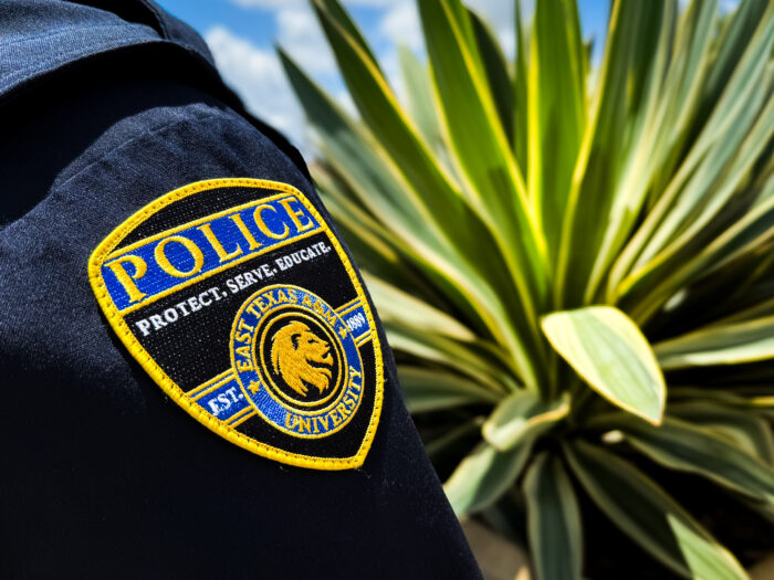 University police badge on officer uniform.