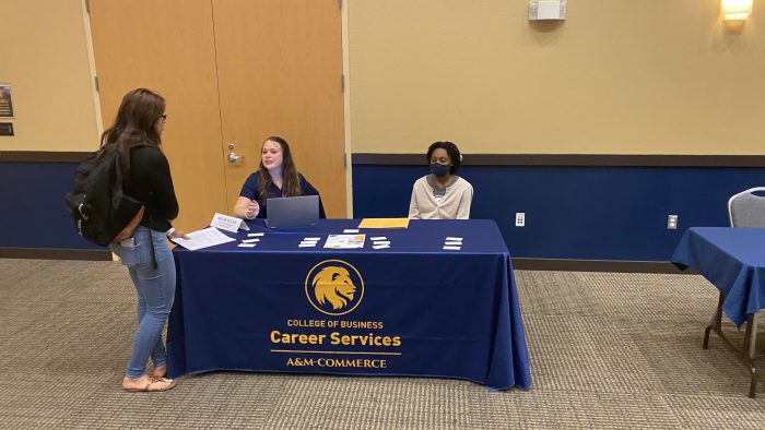 three women at table of Meet the Firms event