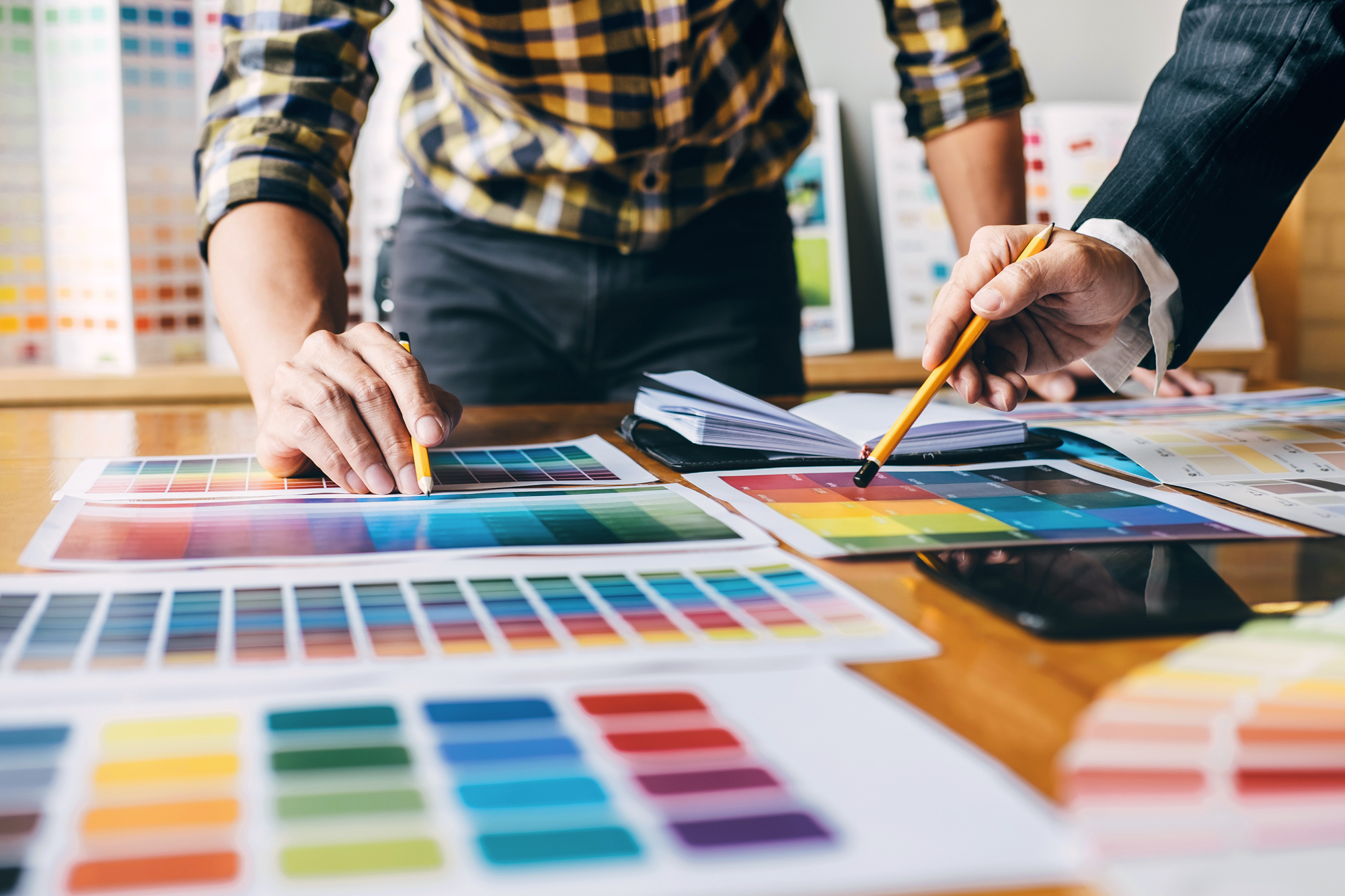 Two individuals looking at color palettes .
