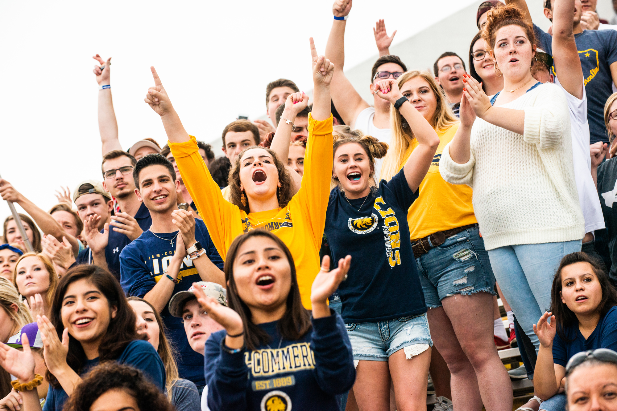 A group of students looking at something in the background, celebrating an event.