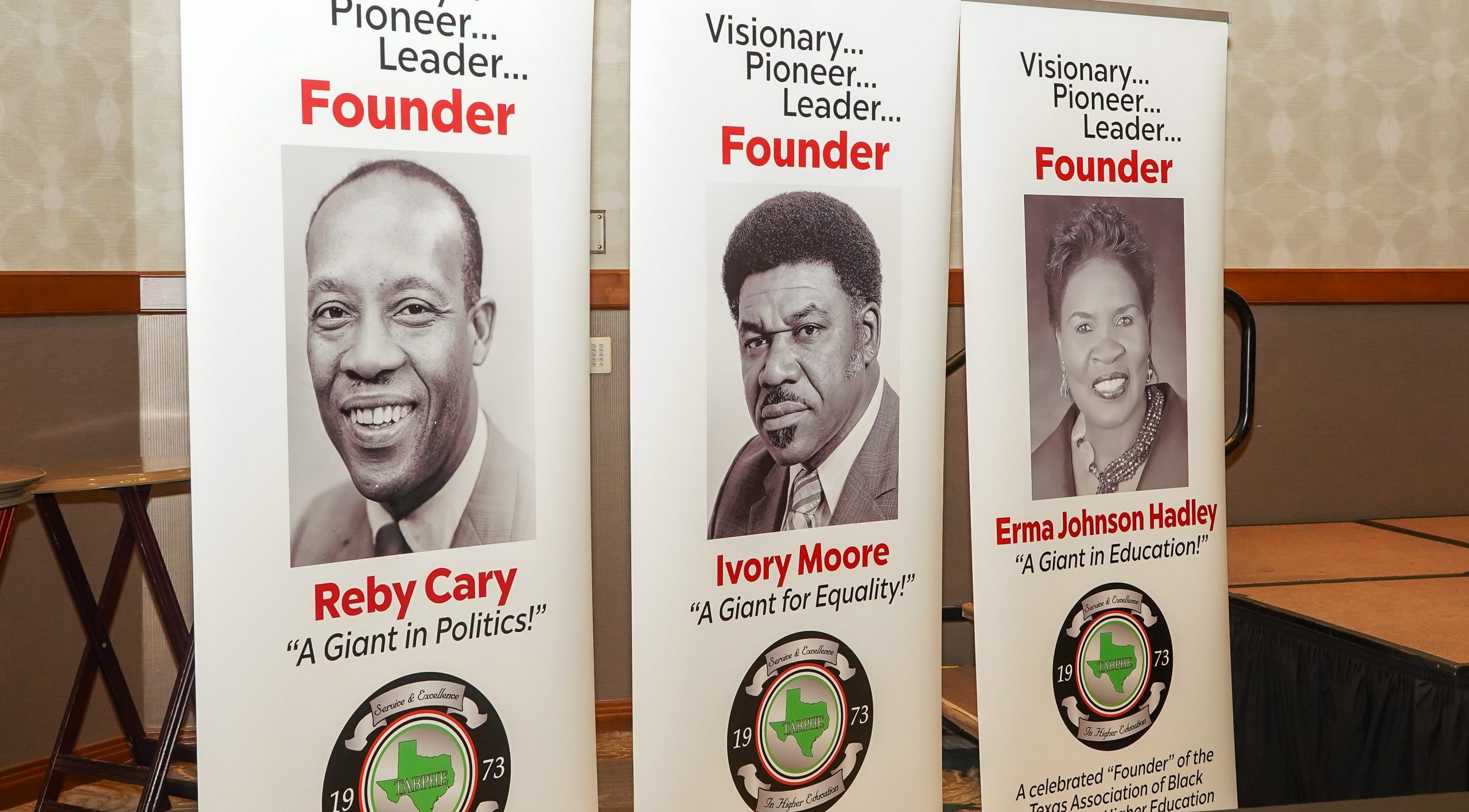 Vertical floor banners portray the three founders of the Texas Association of Black Personnel in Higher Education.
