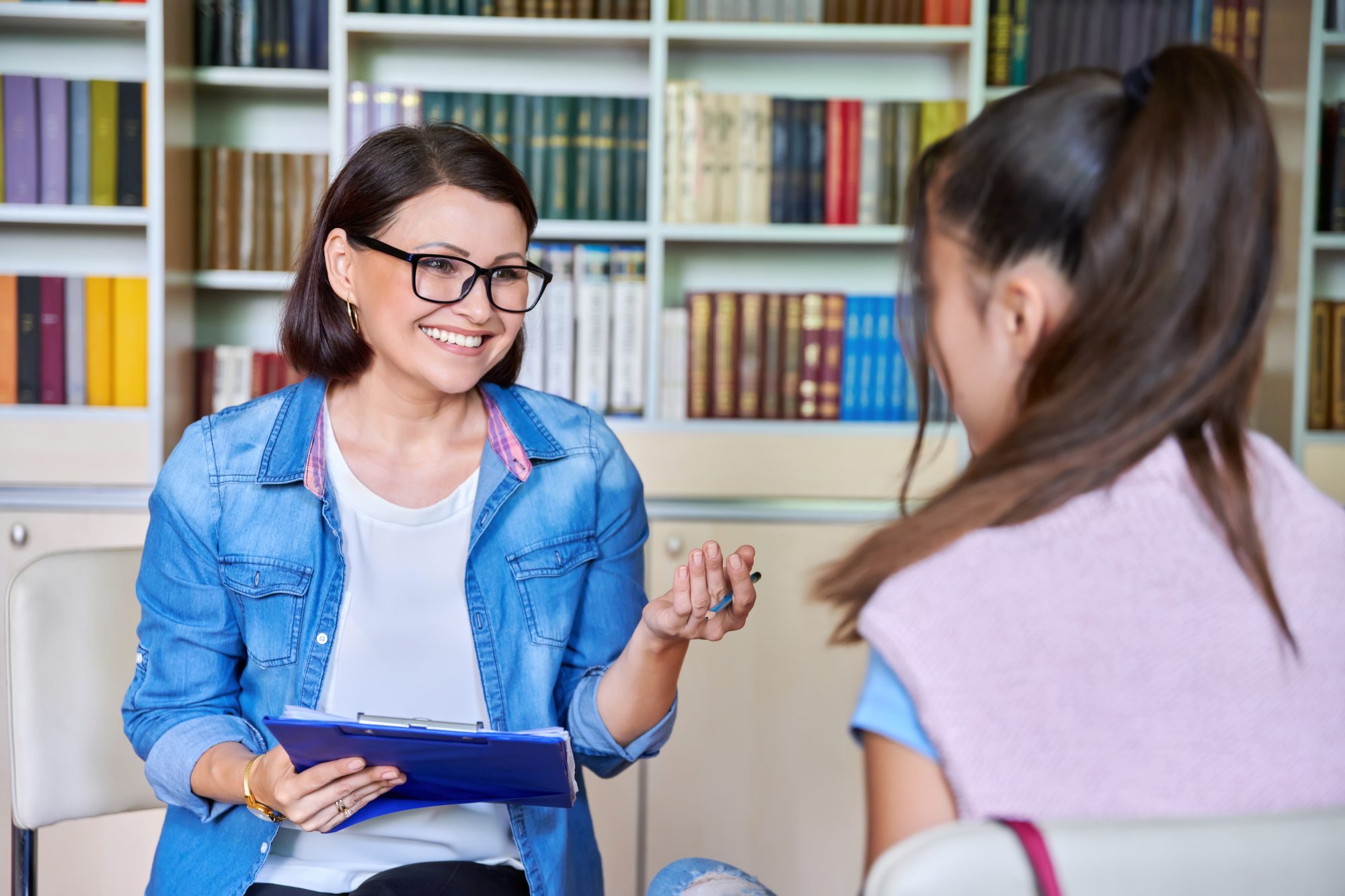 A female mentor asking some questions to another female student.