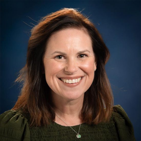 Headshot of Kathryn Dixon, a woman with white skin and long red hair.