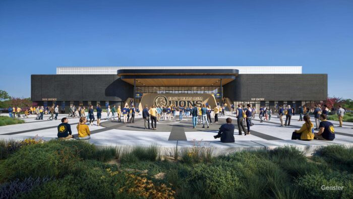 Computerized mockup of front of Event Center shows rectagular gray building with white concrete in front of it. People are walking around in the front of the building.