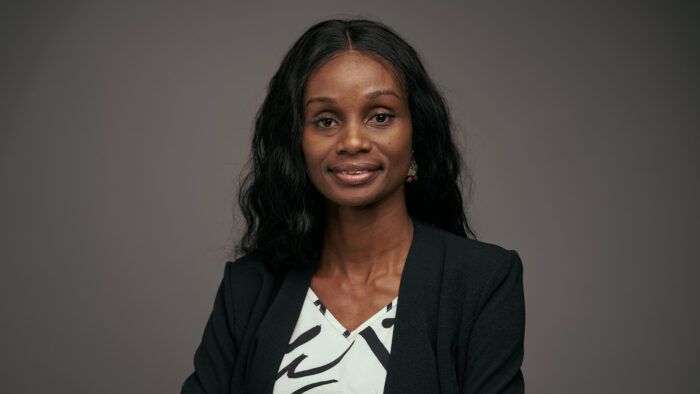A headshot photo of a person in business attire.
