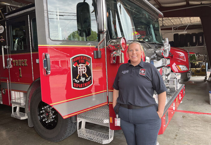 A firefighter standing in front of a fire truck.