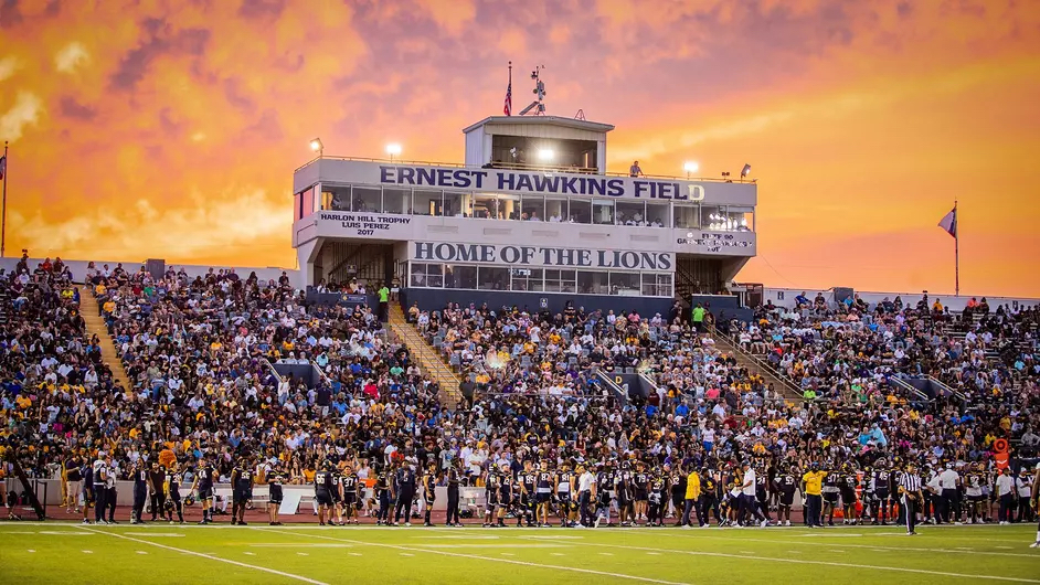 A photo of a college football stadium during a game.