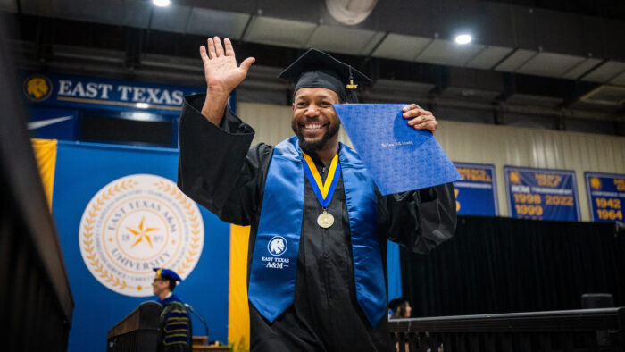 A college graduate celebrates after receiving their degree.