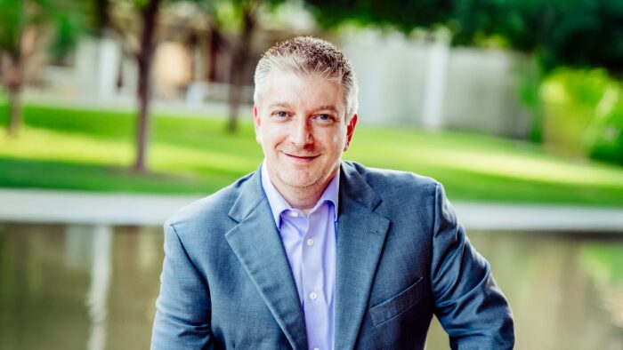 Man sitting outside smiling.