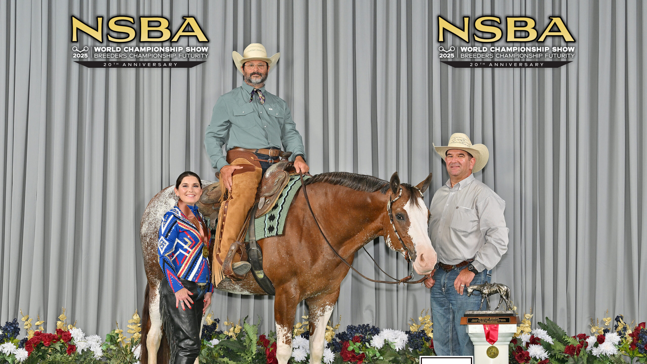 A person is mounted atop a horse. Two people are flanking each side of the horse.