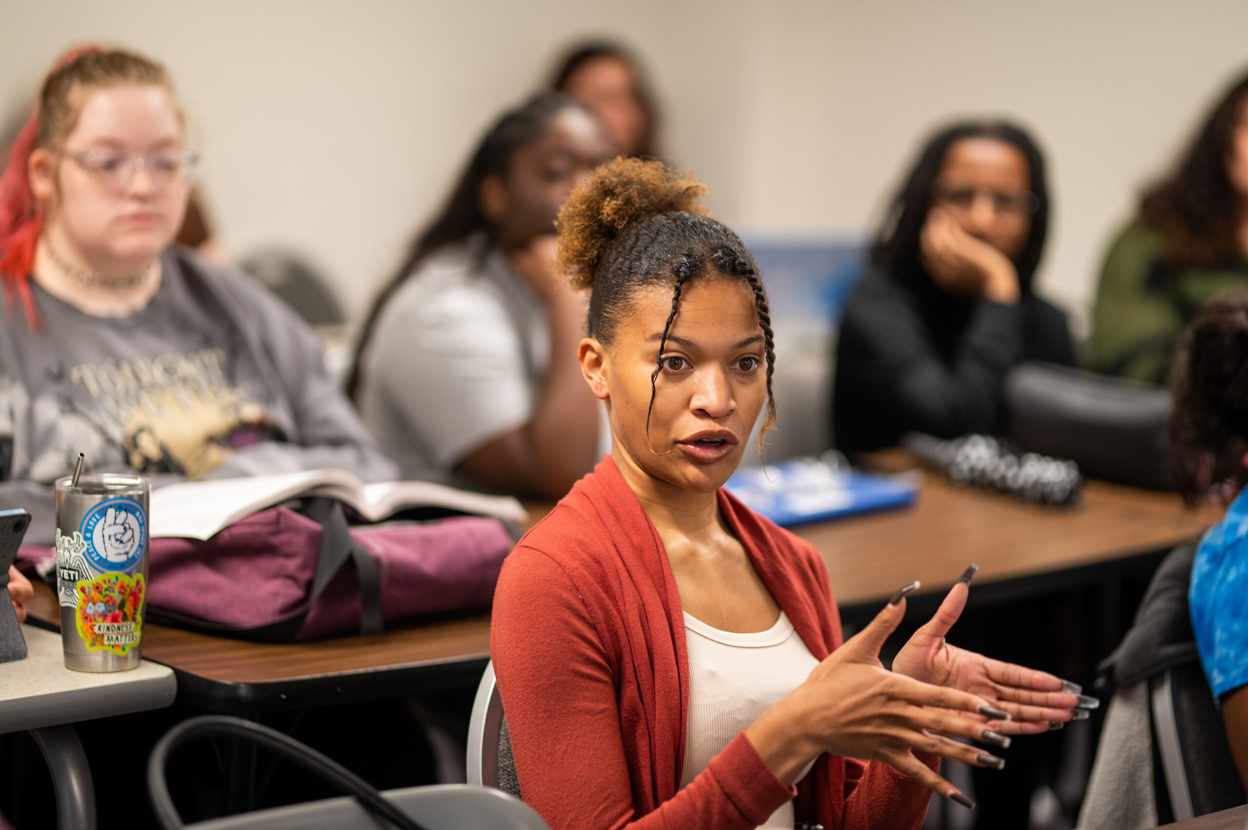 Classroom with young people sitting behind desks.