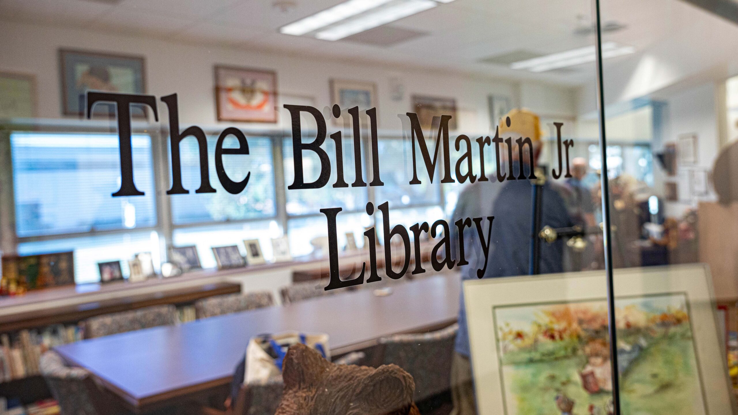 A glass wall with the title "The Bill Martin Jr Library' stenciled on it.